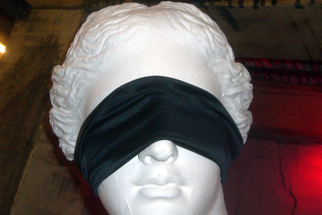 Photo of a blindfold over the face of a statue.