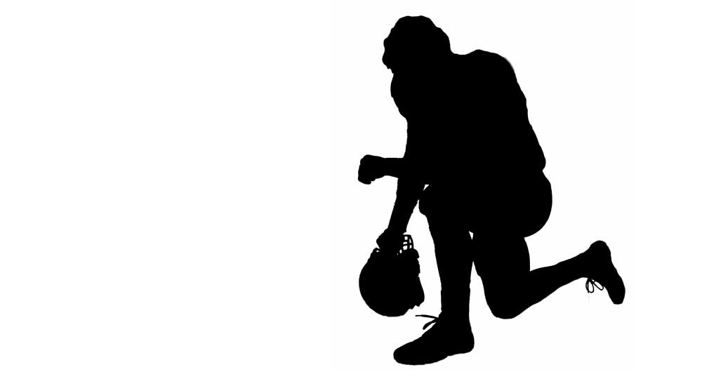 Silhouette of a kneeling football player
