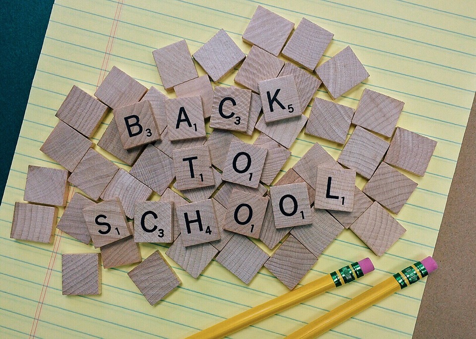 Scrabble letters spell out "back to school"