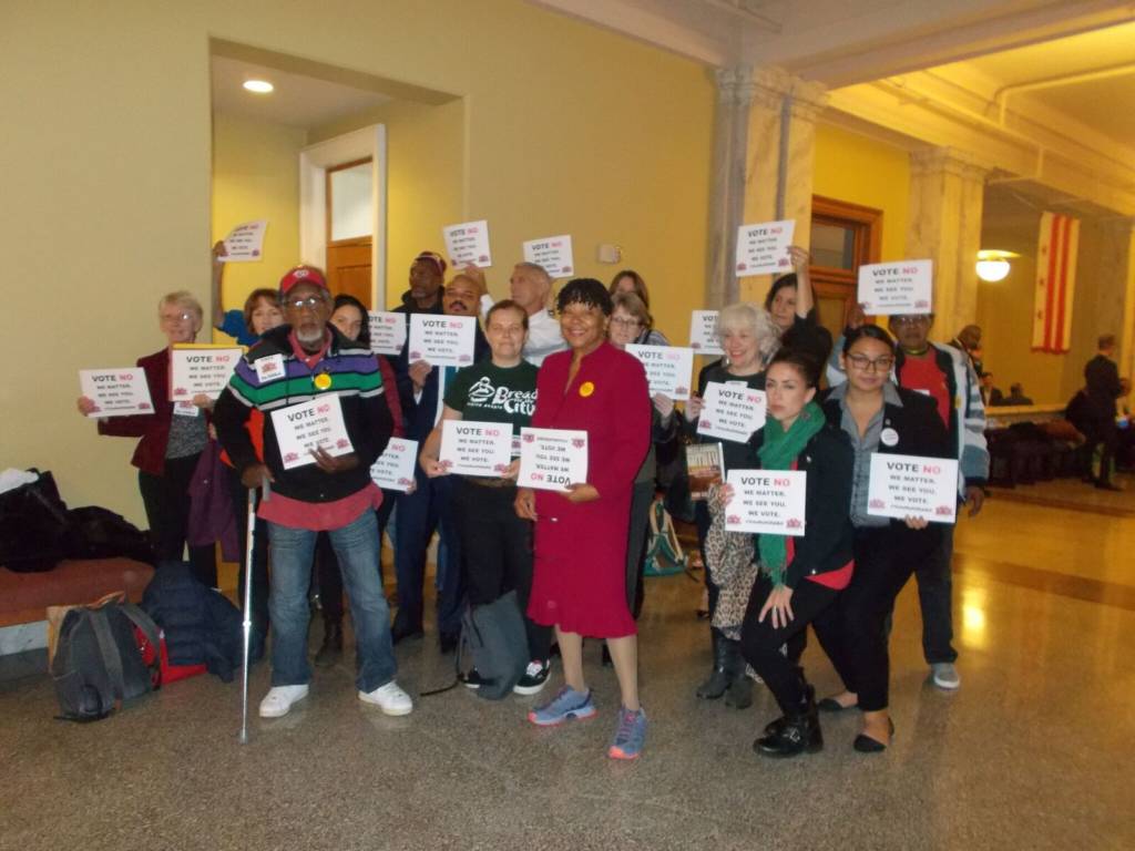 Advocates, homeless people, and formerly homeless people, including Edith Glasco, gather to oppose the HSRA bill in the Wilson building.
