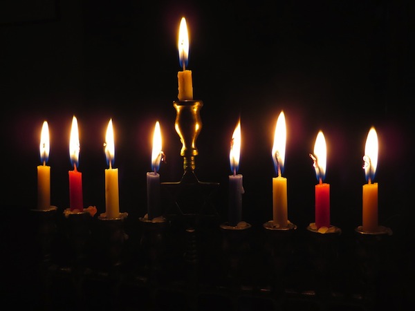 A menorah glows with 9 lit candles