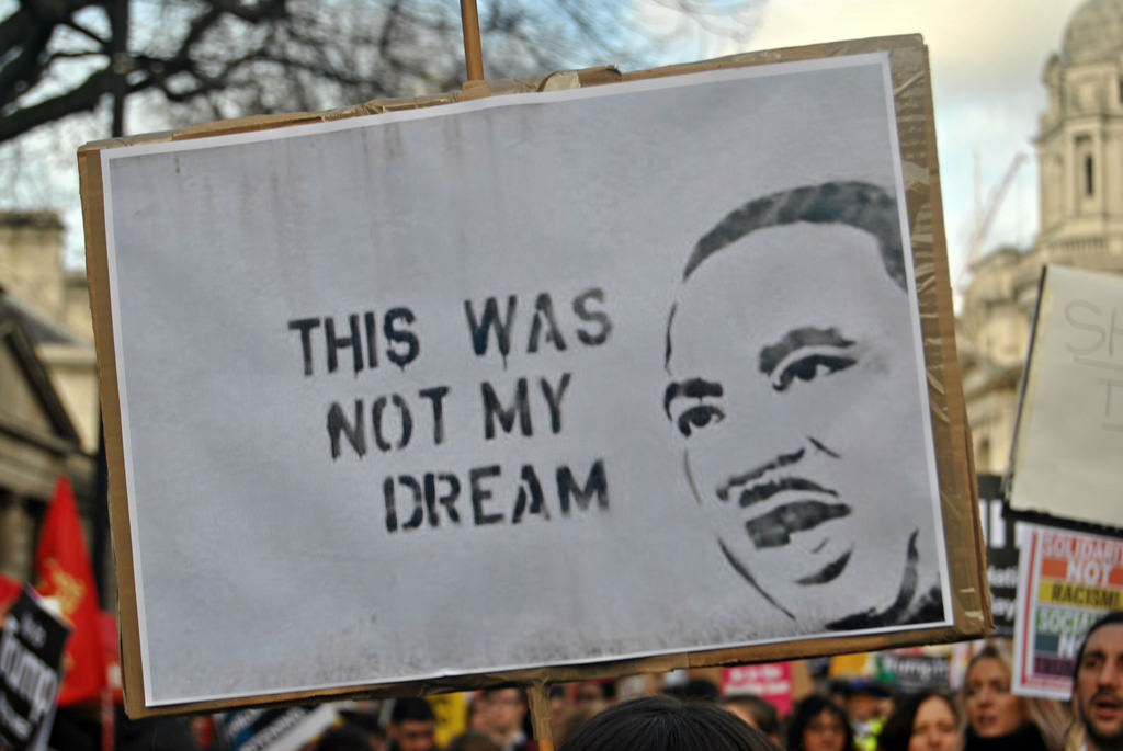 A sign with a picture of Martin Luther King, Jr., and the words "This was not my dream"