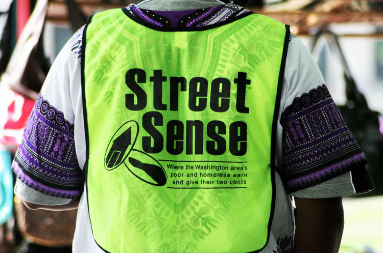 Photo of the back of a street sense vendor vest