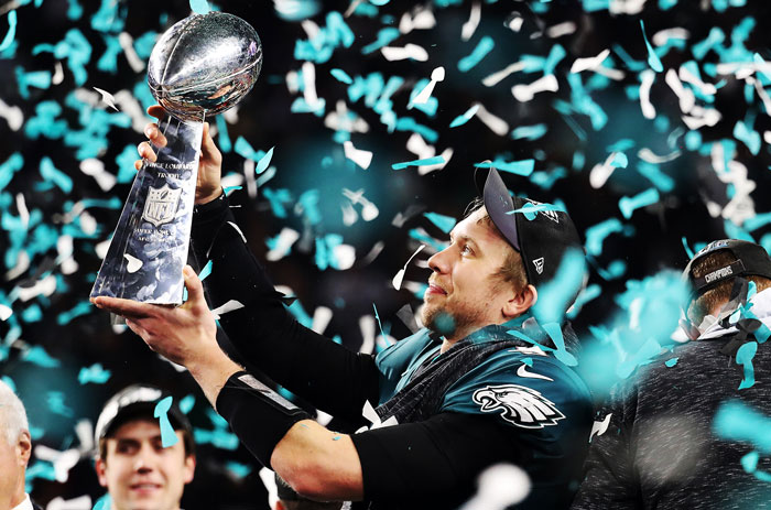 Nick Foles of the Eagles holds up the Vince Lombardi Trophy as confetti falls around him