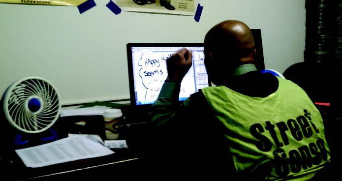 Vendor Chino Dean working on his new comic strip, Klever’s Comics.