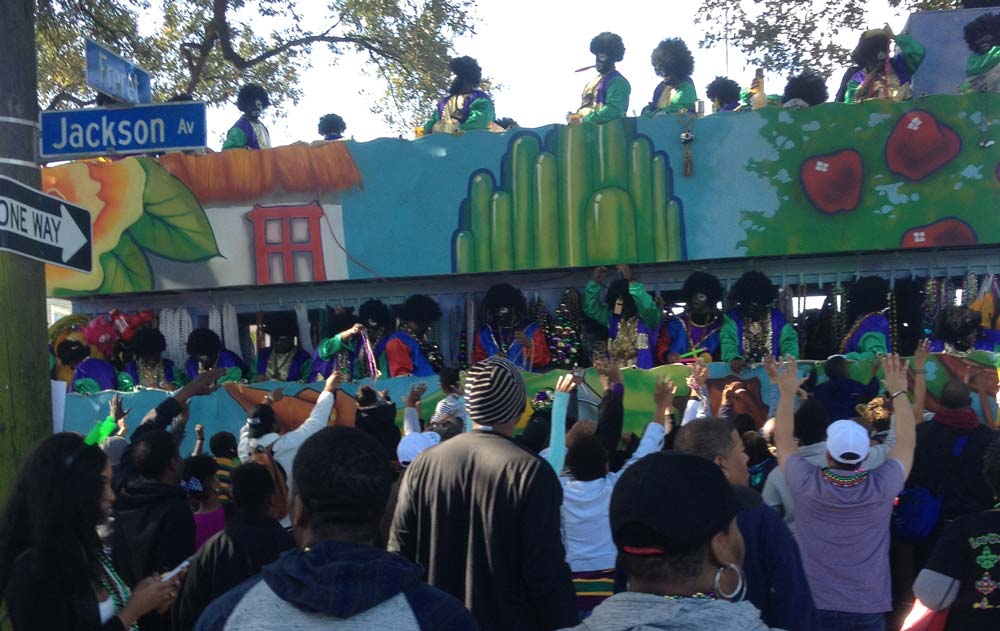 A crowd in front of a Mardi Gras float