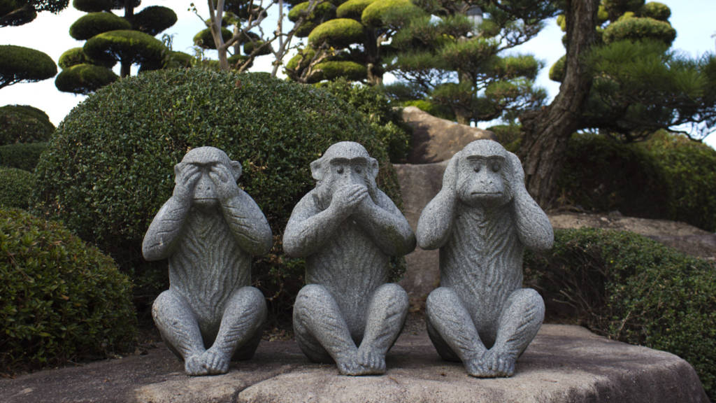 Photo of a statue of the Three Wise Monkeys, a visual from Japanese culture and the philosophy of Confucius. The represent the acts, "See no evil, speak no evil, hear no evil."