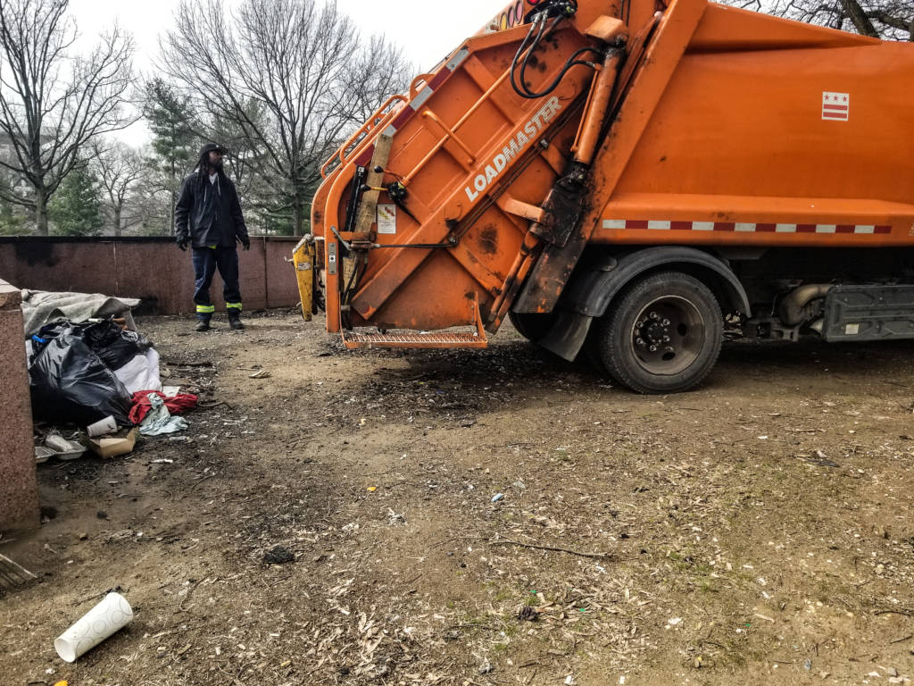 Workers cleared the E Street site with a garbage truck