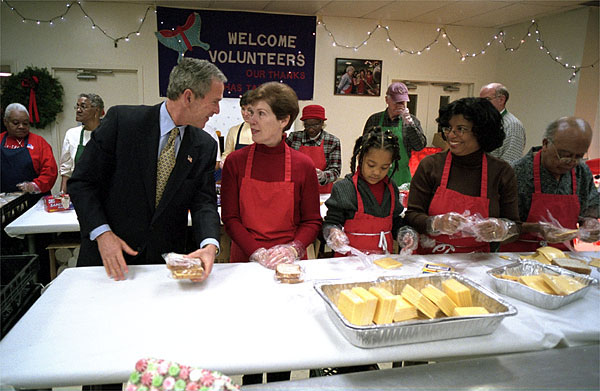 Visiting "Martha's Table" center for homeless adults and children, President George W. Bush talks with volunteer Connie Jeremiah December 20. The president helped pack sandwiches into carrying crates at the center which has been providing food to the hungry since 1980.