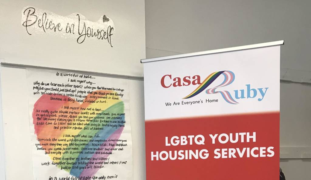 A picture of a poster in front of Casa Ruby office of LGBTQ youth housing service