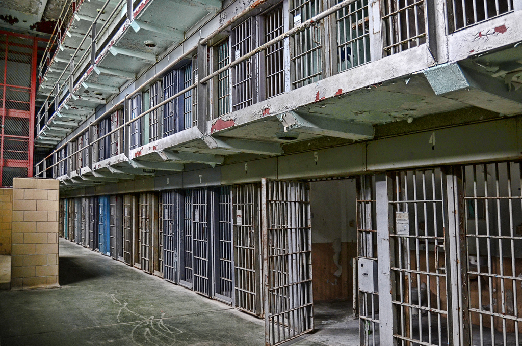 Photo of a row of two floors of jail cells.