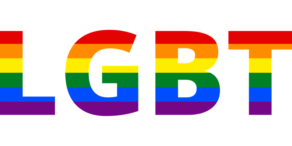 Image of the word LGBT each letter symbolized with a rainbow array of colors.