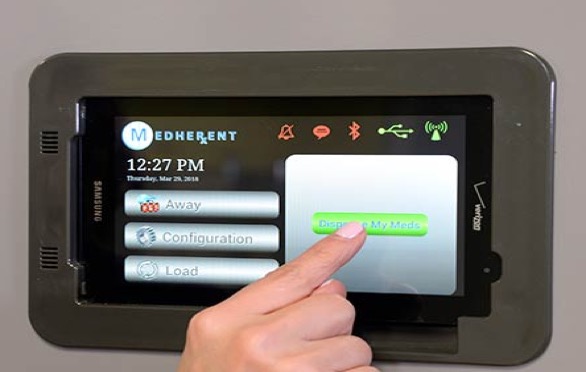 Medherent dispensing tablet on the wall with notifications about when to take the medication