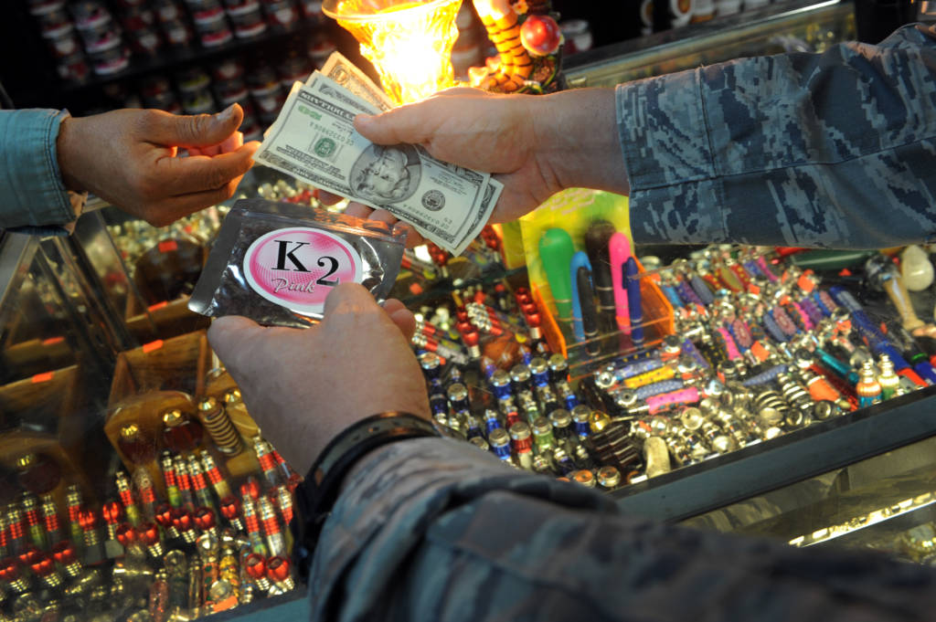 A staged photo illustration showing money and a K2 package being held by someone in a convenience store. LAS VEGAS -- In January 2010, Lt. Gen. Stanley T. Kresge, former commander of the U.S. Air Force Warfare Center, issued a general order banning the use of Spice, Salvia Divinorum, and Salvinorin in any form by members of the Nellis and Creech Air Force Base communities. The order prohibits the purchase, distribution or possession and use of any Spice product. Spice was legal to sell in the civilian community until Nov. 24, when the Drug Enforcement Administration used its emergency powers to ban Spice and other products that mimic the effects of marijuana. Spice is made in many different varieties, all of which have a disclaimer identifying it as incense not for human consumption.
