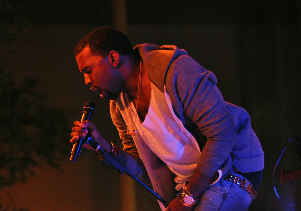 A photograph of hip-hop artist Kanye West in performance.