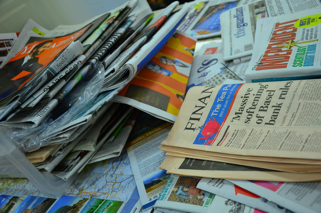 A photograph of a pile of newspapers.