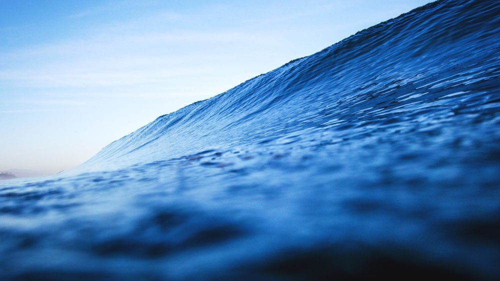 A photograph of a blue ocean wave.