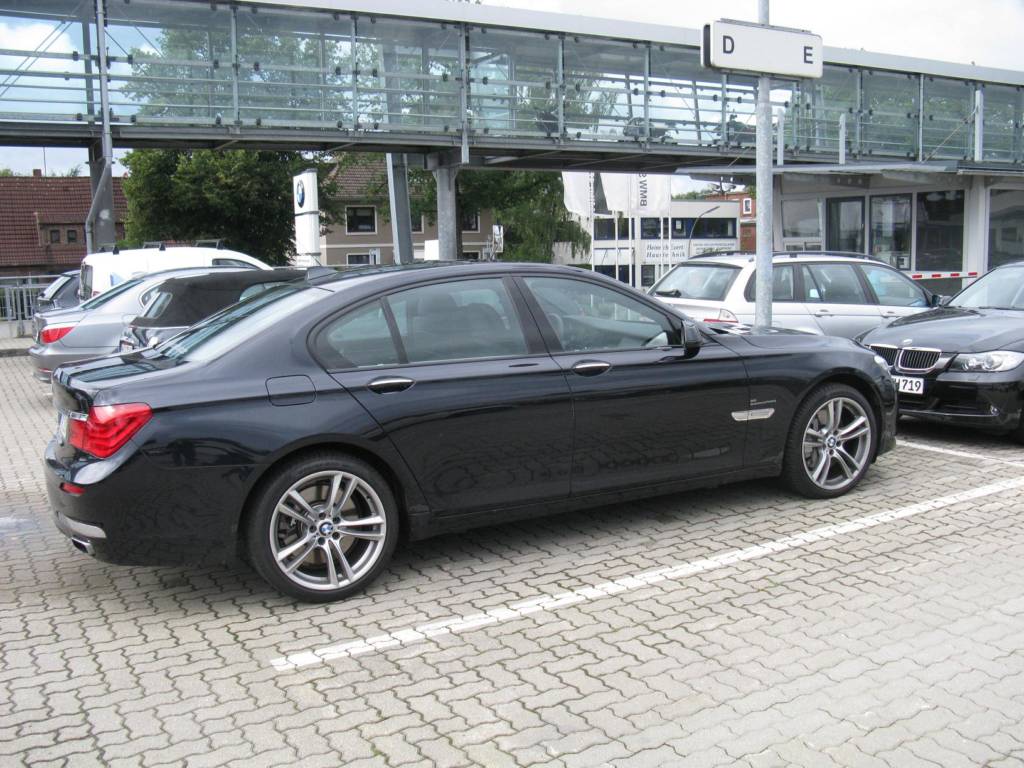 Black BMW 750 in parking lot