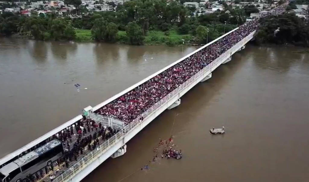 An areal view of thousands of Central Americans filling the Guatemala Border Bridge.