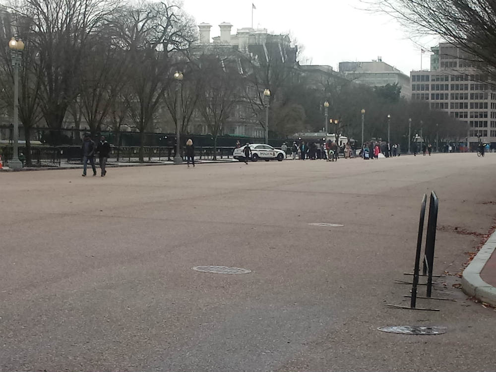 Color photo of an empty Pennsylvania Avenue between the White House and Lafayette Square