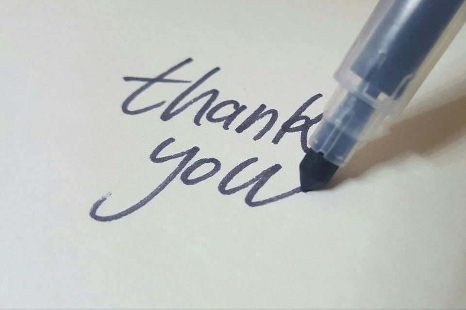 Photo of a pen that has just written the words "thank you"