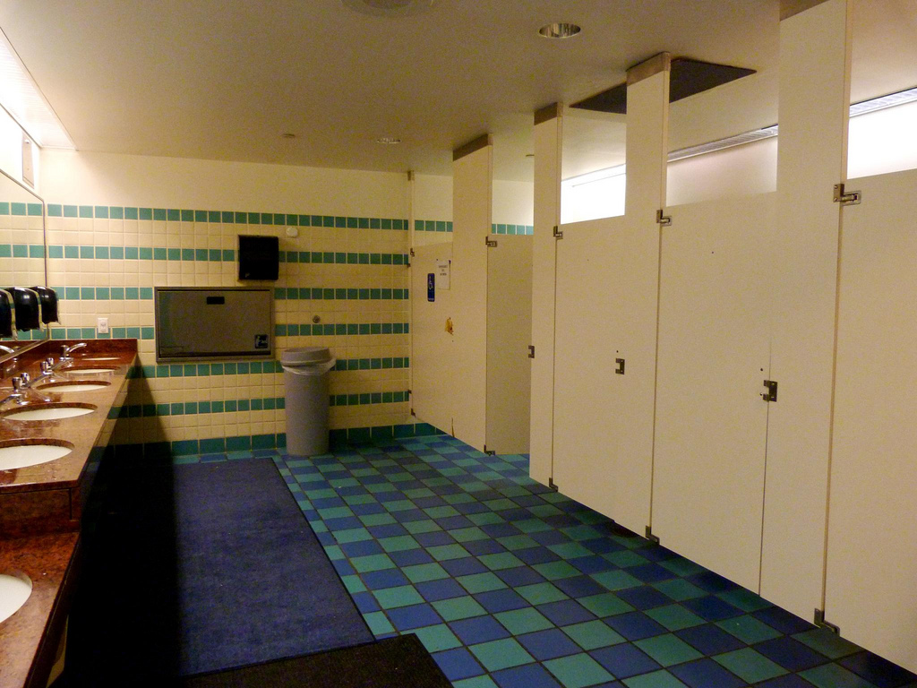 A photo of a public restroom with a blue and green checkered floor