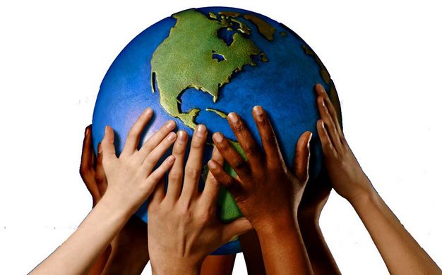 A photograph of many hands holding up a globe.