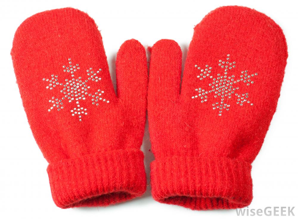 A photograph of red mittens with embroidered snowflakes.
