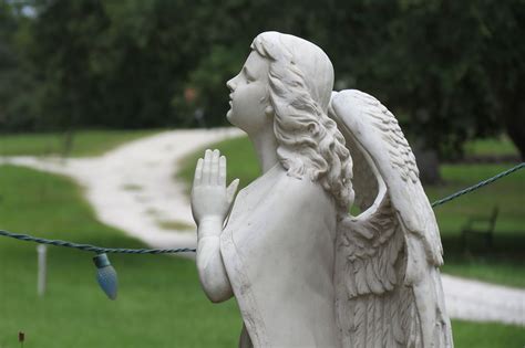 A photograph of a statue of a praying angel.