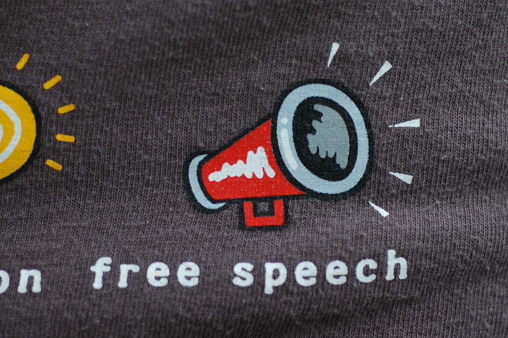 A photo showing a t-shirt that says "Free Speech" with a megaphone.