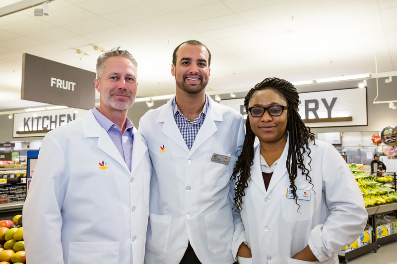 Photo of three pharmacists wearing white coats with the Giant logo.