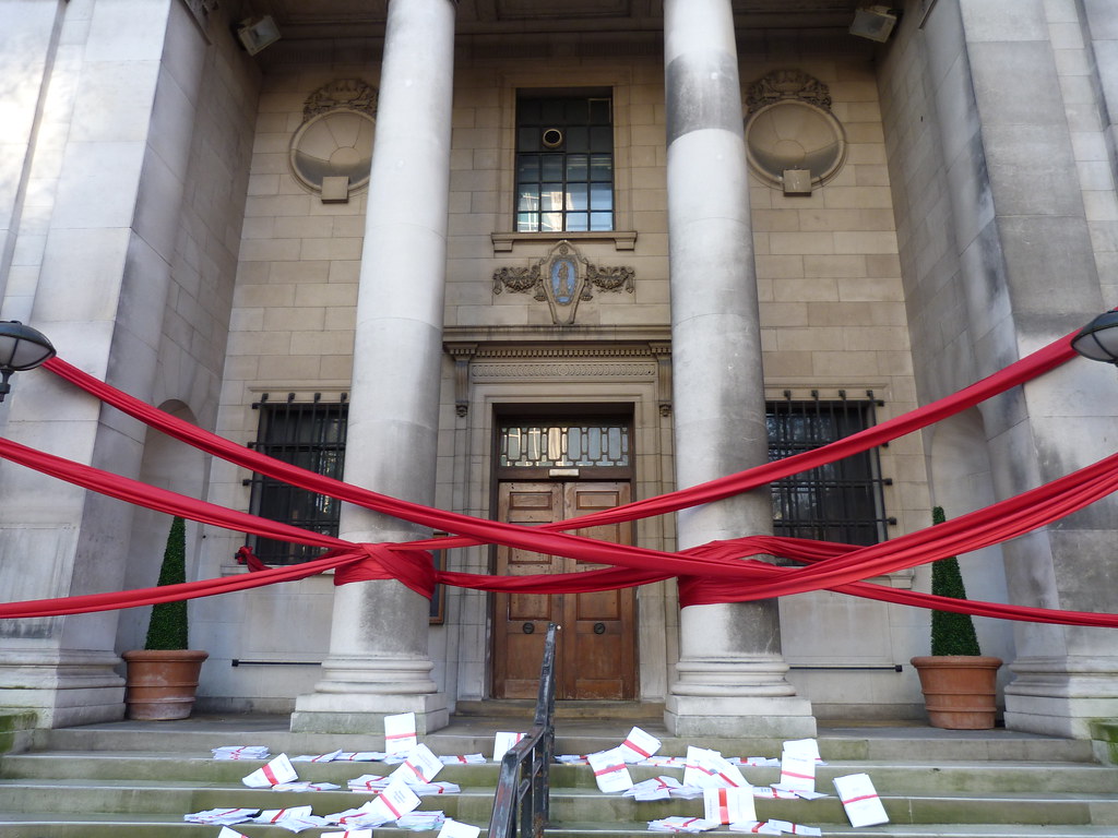 Photo of front of building covered in red tape