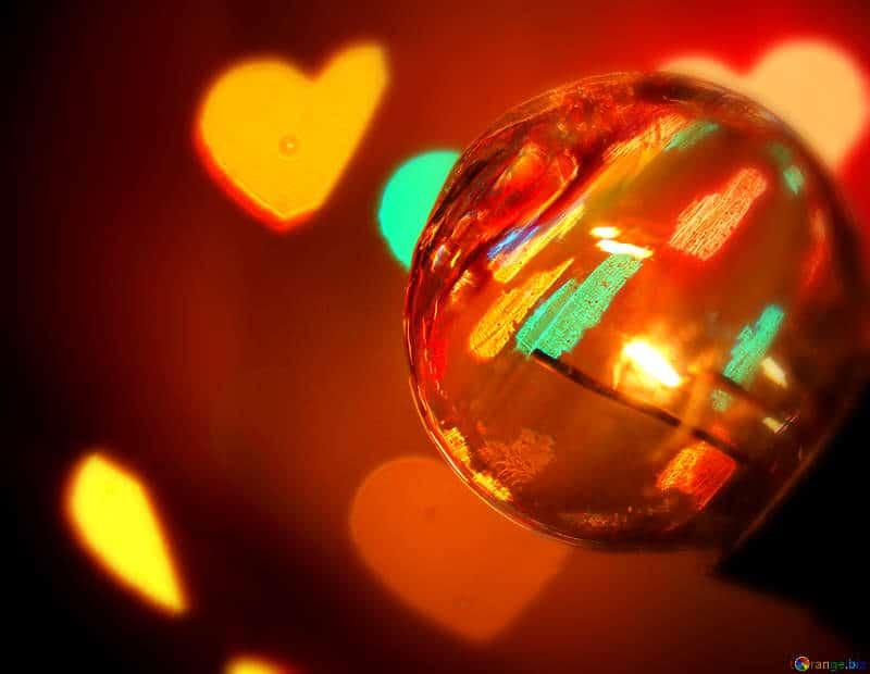A photo showing a reflective ball and hearts.