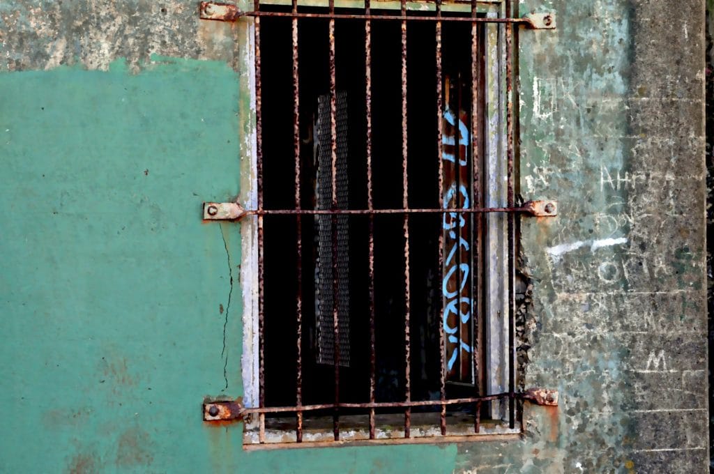 A photo showing a rusted prison window.
