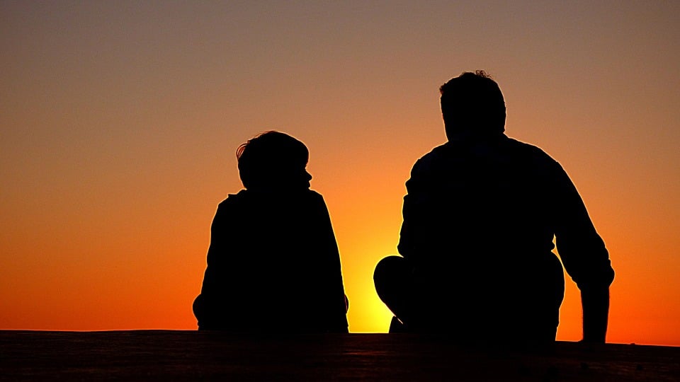 A picture showing the silhouette of a father and son.