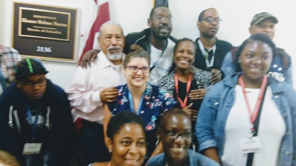 A photo showing a group of advocates from the National Alliance to End Homelessness in front of Eleanor Holmes Norton's office.
