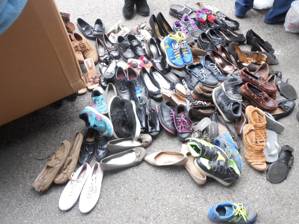 Photo of various used shoes of different sizes and colors.