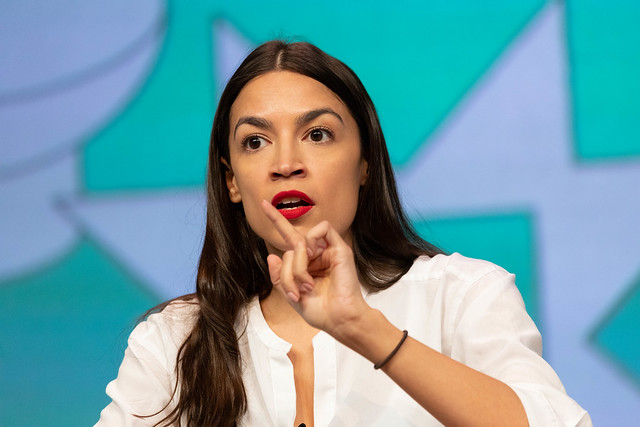 Alexandria Ocasio-Cortez points at the crowd during the 2019 SXSW conference.