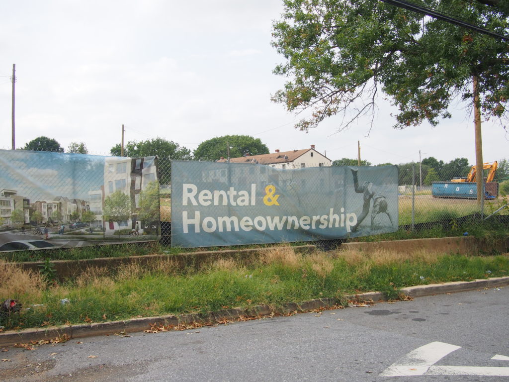 A photo of a banner that reads "Rental & Homeownership".