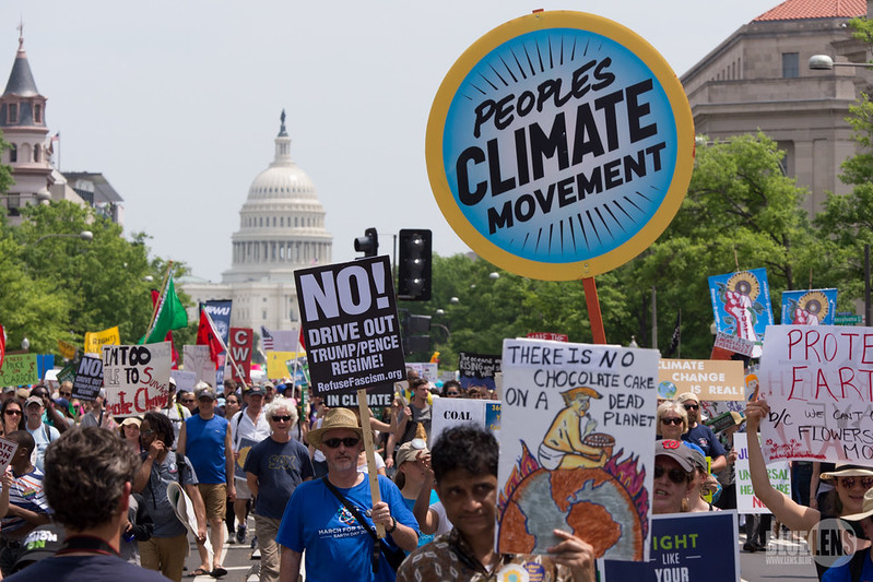 Protestors march on Washington during climate march, wielding colorful signs