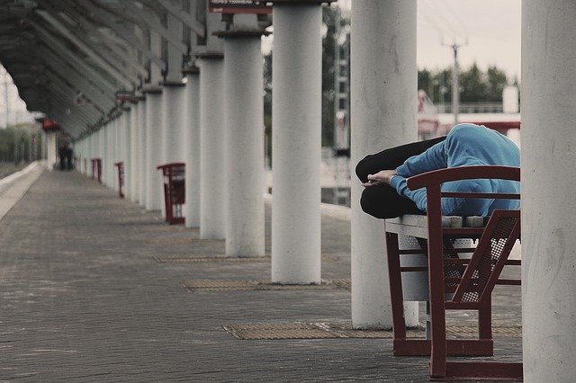 Image of person lying on a bench