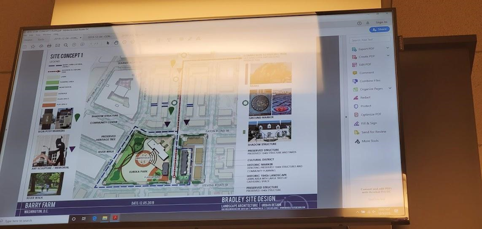 A picture of a monitor showing the Barry Farm site concept design plan.