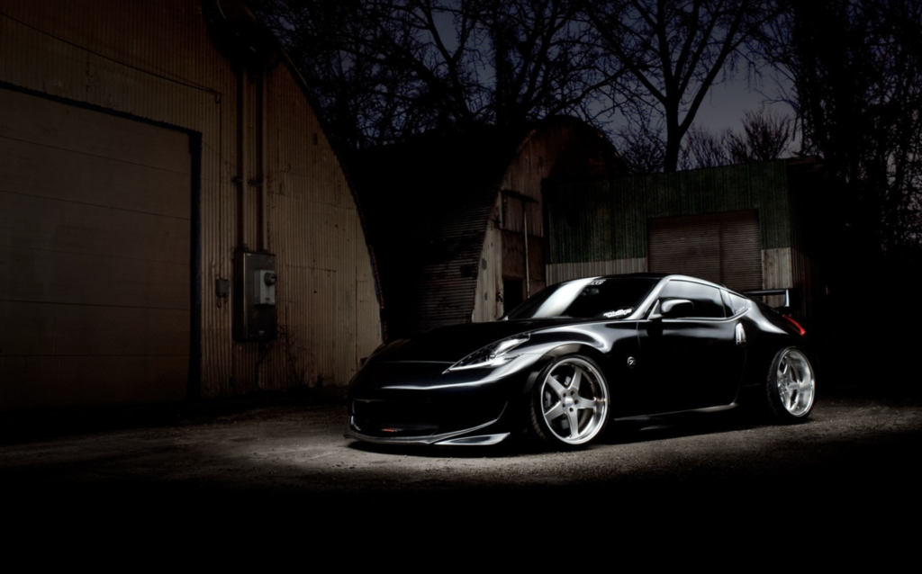 An image of a black car at night.
