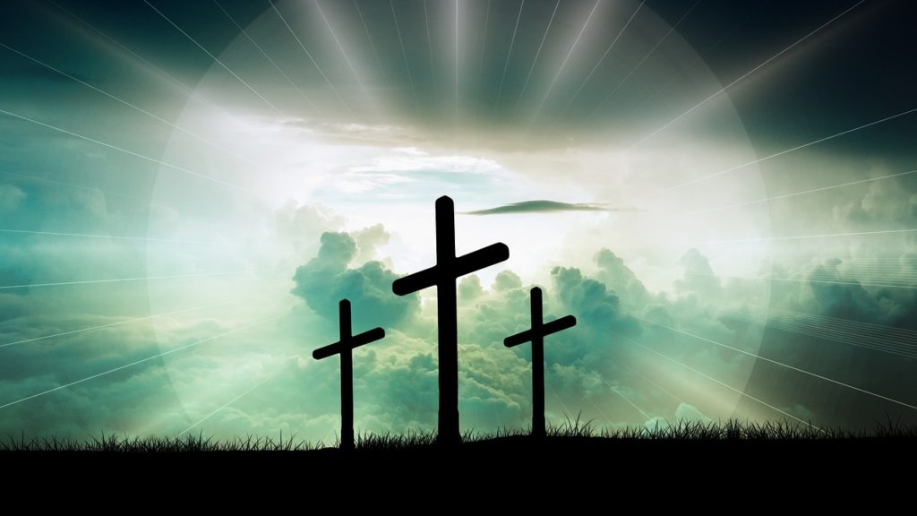 An image of three crosses illuminated by sunlight