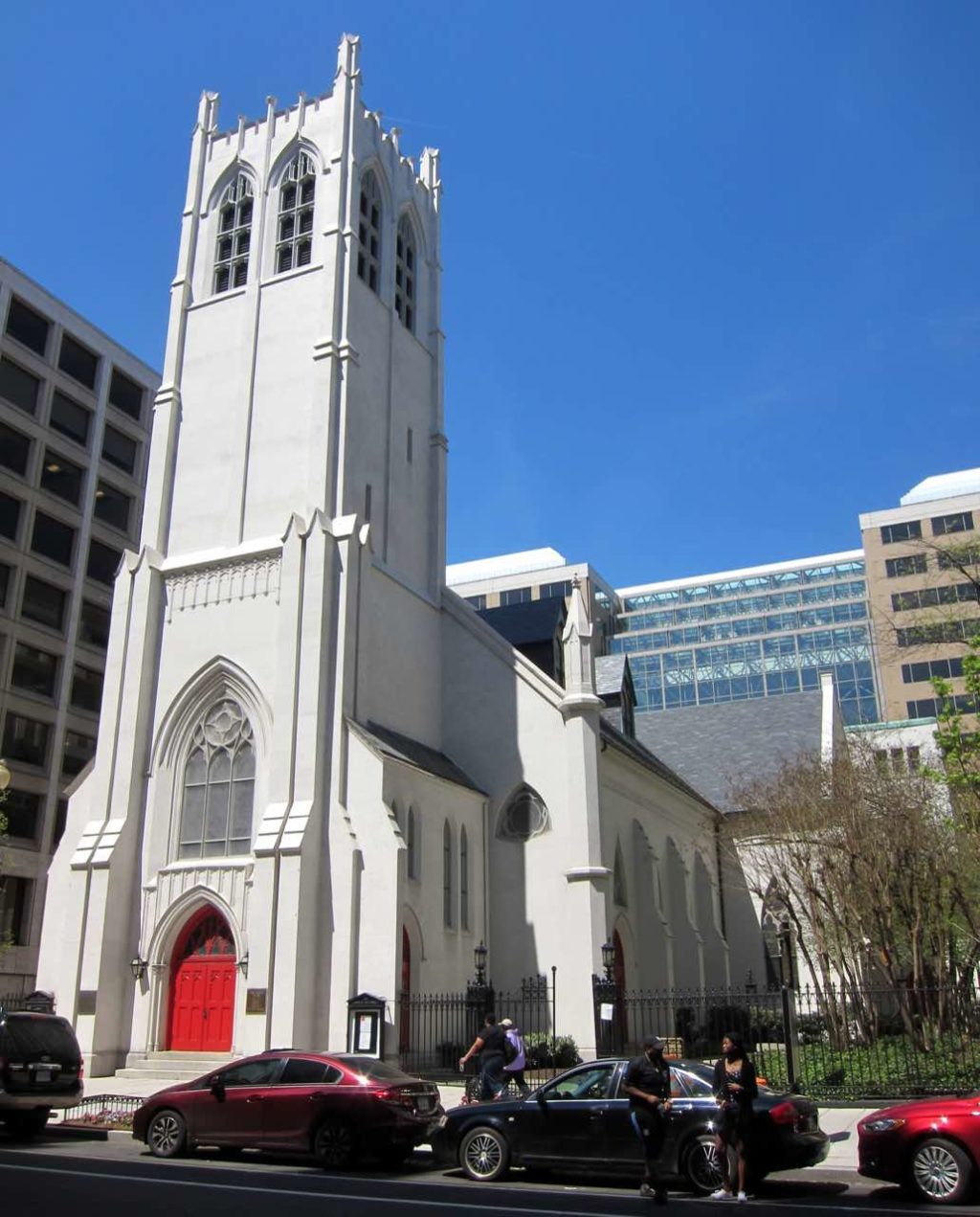 A white church building in front of a blue sky