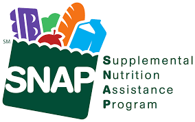 A graphic depicting the SNAP program. A green bag that includes bread, an apple, milk