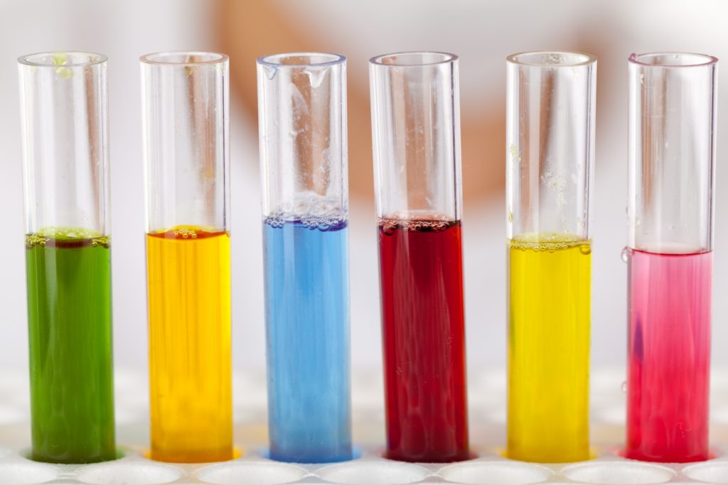 A row of test tubes with colorful liquids.