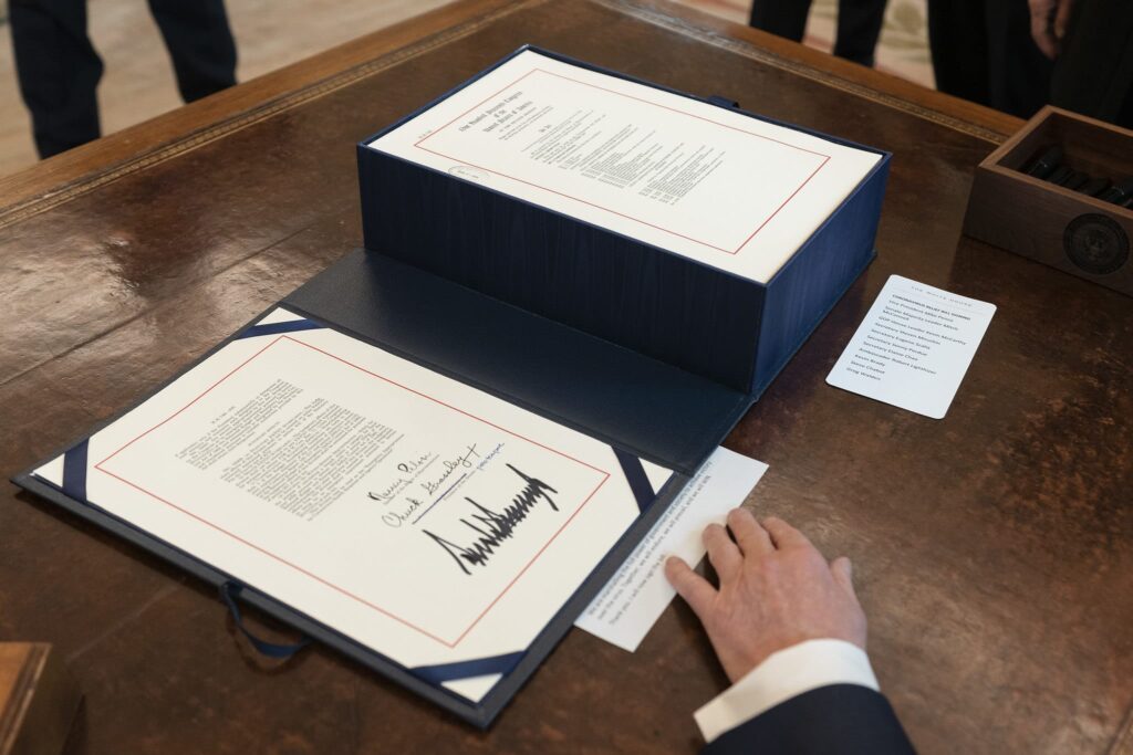 Photo of a signed bill on President Donald Trump's desk.