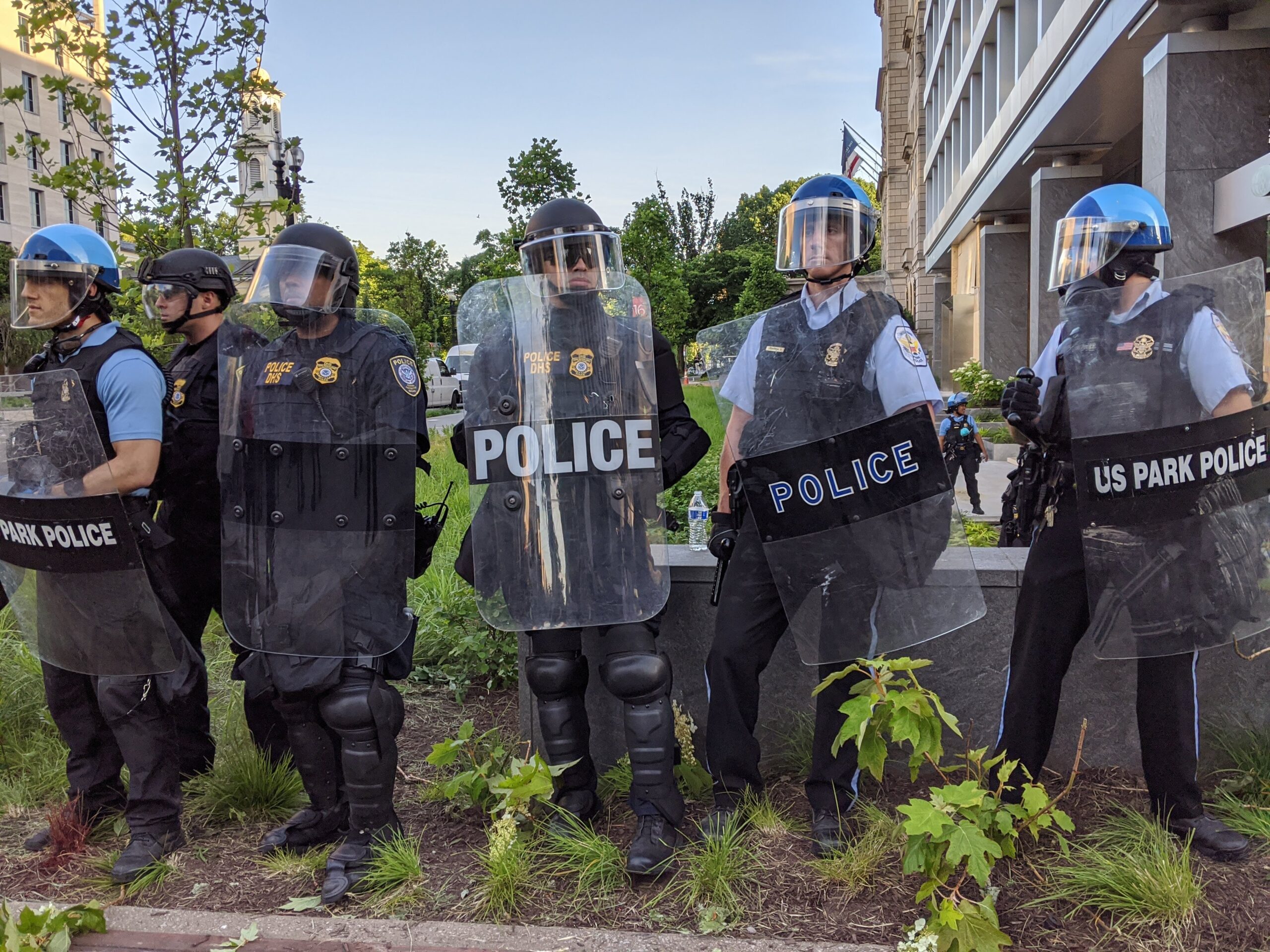 Photo of police lined up in riot gear