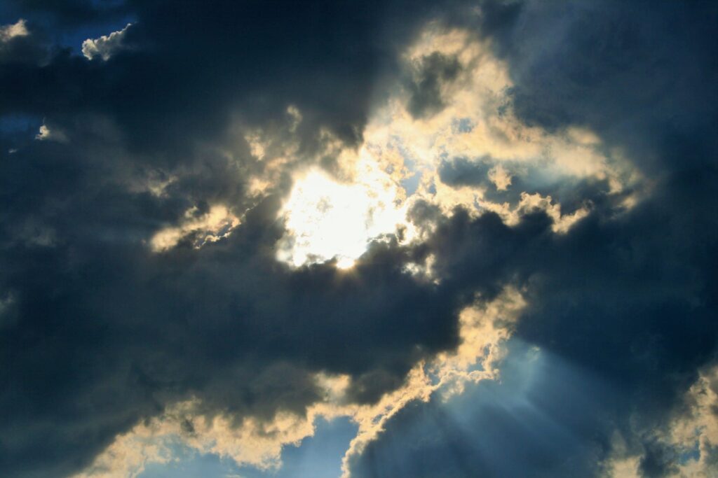 Photo of light shining through clouds